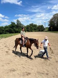 a man riding a horse next to a man with a spear at SONEKA in Kitahiroshima