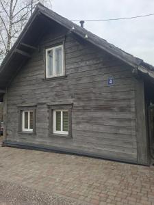 a house with two windows on the side of it at Pavasari in Cēsis