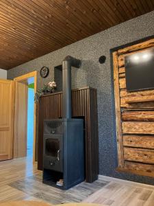 a wood stove in a room with a wall at Pavasari in Cēsis +2 photos