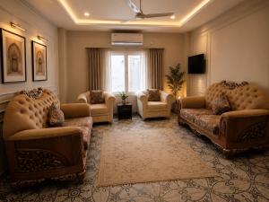 a living room with couches and chairs and a window at Hotel Granton By Carlton Suites in Hyderabad +47 photos