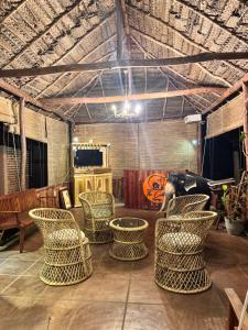 a room with a group of chairs and a table at The Cottage Sigiriya in Sigiriya