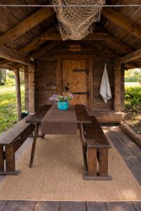 a picnic table and benches on a patio at Sepasauna holiday house in Joaveski