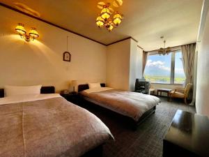 a hotel room with two beds and a window at Shoji Lake Hotel in Fujikawaguchiko +30 photos