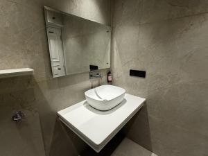 a bathroom with a toilet on a counter with a mirror at Hotel Bloom Residency in Dehradun