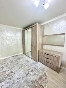 a bedroom with a large bed and a window at Apartment Plaza tower in Shymkent +1 photo
