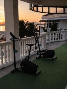 two exercise bikes on the balcony of a house at Hotel Millenium deluxe in Selce
