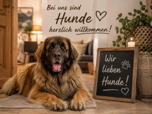 a large brown dog laying on the floor next to a chalkboard at FichtelLOFT Retreat-Design Loft nahe Bayreuth in Goldkronach