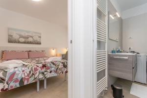 a bedroom with a bed and a sink in a room at Al Col de Foia in Agordo