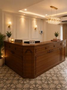 a large wooden reception desk in a room at Hotel Granton By Carlton Suites in Hyderabad