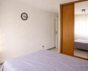 a bedroom with a bed and a clock on the wall at Rooms in Palma Center in Palma de Mallorca +3 photos