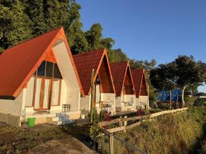 a row of houses with red roofs on a hill at Roman Villa Syariah in Sembalun Lawang