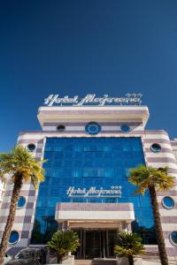 a building with a sign on top of it at Hotel Majorana in Rende