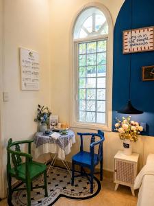 a room with a table and two chairs and a window at Green Hillside Villa Hue in Hue