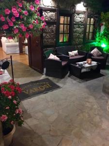 a living room with couches and flowers at Varosi Guesthouse in Edessa