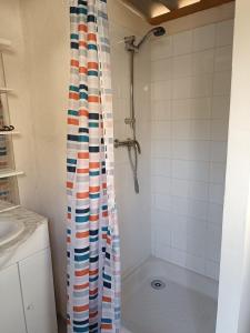 a shower with a colorful shower curtain in a bathroom at Yachting lodge 83 in Sanary-sur-Mer