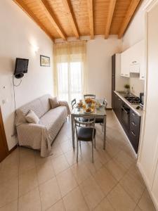 a living room with a couch and a table at Residence Caorle Apartments - Agenzia Cocal in Caorle