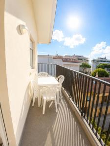 a patio with a table and chairs on a balcony at Residence Caorle Apartments - Agenzia Cocal in Caorle