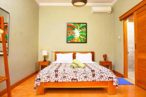 a bedroom with a bed in a room at Villa Joglo Kawung - City Centre Paradise with Pool in Yogyakarta +19 photos