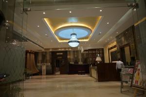 a lobby with a ceiling with a chandelier at Palmdale Hotel & Resort in Ambāla +15 photos