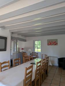 a dining room with a table and chairs at La Maison du temps retrouvé in Berville