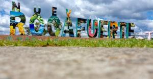 a sign that says berlin in front of a field at Hostal Yurag Wasi in Nuevo Rocafuerte