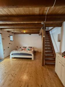 a bedroom with a bed in a room with stairs at Rustico Indéman in Gambarogno