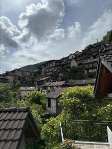 a group of houses on a hill in a town at Rustico Indéman in Gambarogno