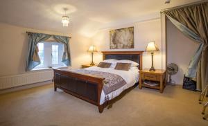 a bedroom with a large bed and a window at The Old Rectory Chicklade in Chicklade
