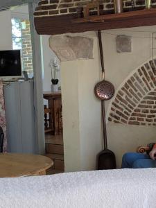 a room with a table and a lamp on the wall at La Maison du temps retrouvé in Berville
