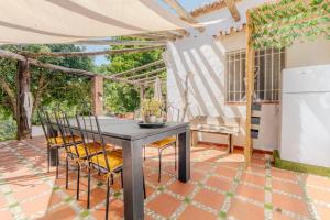 a dining room with a table and chairs on a patio at La Casa del Burro in Nerja