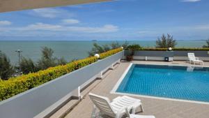 a swimming pool on the side of a building at Avatara A condominium C41 with sea view in Ban Tha Fat