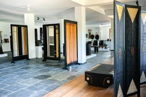 a room with three doors and a bench on the floor at Heirloom Guesthouse in Dimāpur