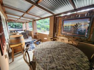 a room with a bed and a large window and a television at Pink Pepper Yard in Uniondale