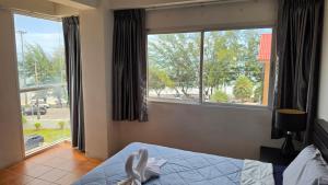 a bedroom with a bed and a large window at Avatara A condominium C41 with sea view in Ban Tha Fat +23 photos