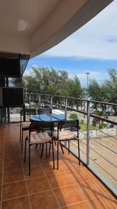 a patio with a table and chairs on a balcony at Avatara A condominium C41 with sea view in Ban Tha Fat