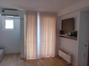 a living room with a large window with curtains at Venecia gold in Struga