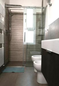a bathroom with a shower and a toilet and a sink at TOSCANA HOME in Ravenna +50 photos