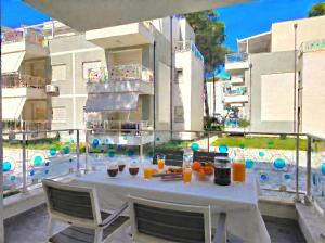 a table with oranges and drinks on a balcony at Sunny Beach Apartments - 147 in Durrës