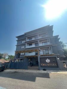a tall building with a sign in front of it at Casa Sevara Hotel in Vagator