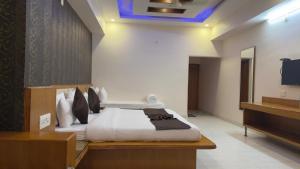 a hotel room with a bed and a television at Hotel Panigrahan in Bikaner