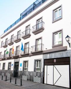 a white building with a large white garage at Plaza de la Luz Cádiz in Cádiz