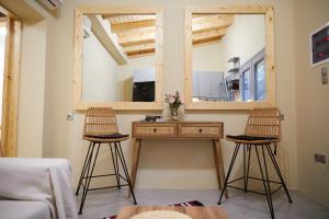 a room with two stools and a mirror at The Beach House at Oz Bay in Pantoukiós