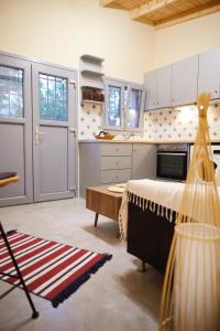 a kitchen with a bed and a table in a room at The Beach House at Oz Bay in Pantoukiós +11 photos