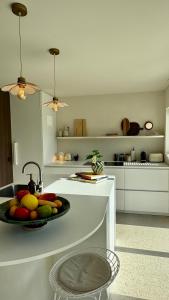 a kitchen with a bowl of fruit on a counter at House W - North Sea Stays in De Haan