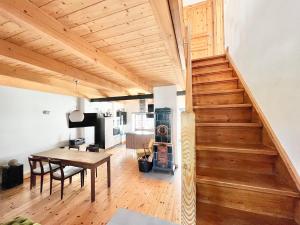 a living room with a table and a staircase at Kachelofenhaus in Fehmarn
