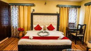 a bedroom with a large bed with a ring on it at Hotel Welcome inn in Patna