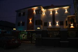 a house with lights on the side of it at night at Akrafthaus by KAVKANZ in Abuja