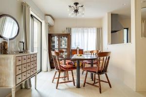 a kitchen and dining room with a table and chairs at Sea Breeze 三浦 in Miura