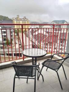 a table and two chairs on a balcony at V Cozy Homestays in Brinchang