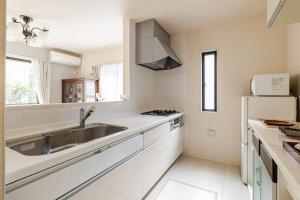 a kitchen with a sink and a refrigerator at Sea Breeze 三浦 in Miura +48 photos